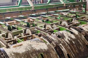 fragment of a line of sawmill equipment inside a modern lumber mill photo