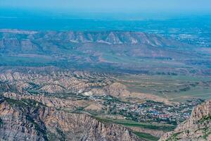 mountain landscape in the Caucasus with a view of the valley of the Sulak River and the towns below on the plain photo