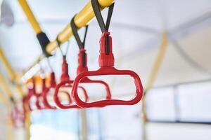 grab handles in the passenger compartment of the bus on a blurred background photo