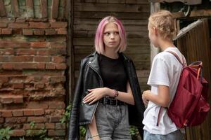 two teenage girls are secret in the courtyard of an old house photo