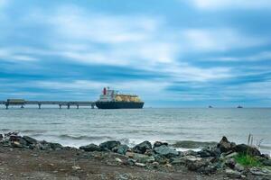 liquefied natural gas carrier tanker during loading at an LNG offshore terminal photo