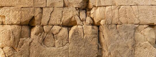 ancient wall texture of large cracked stone blocks photo