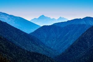 series of mountain ranges to the horizon, blue in the atmospheric haze photo