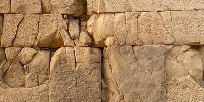 ancient wall texture of cracked stone blocks photo