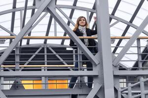 young woman among the urban structures of the covered overpass photo