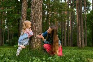 mom and daughter play and have fun in the park photo