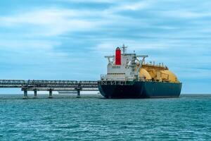 liquefied natural gas tanker vessel during loading at an LNG offshore terminal photo