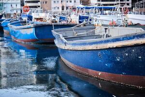 background - small blue fishing boats in the harbor photo