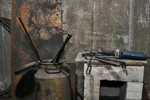 industrial still life - tools and hardened workpieces on a wall background photo