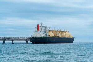 liquefied natural gas tanker during loading at an LNG offshore terminal photo