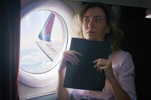 woman being an airplane passenger experiences aerophobia photo