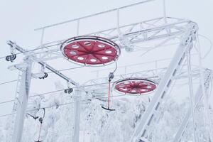 end station of the ski lift on a snow-covered hilltop among frosty trees photo