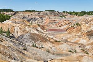 deserted area with a red lake in the place of an old clay quarry photo