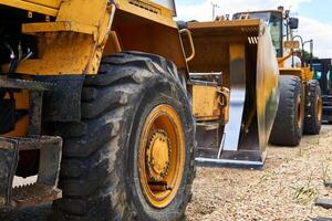 row of standing heavy construction equipment close up photo