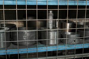 mechanism parts are stored on a shelf behind the bars photo