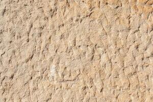 texture of a natural rough-cut stone of an ancient building photo