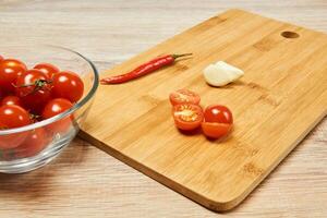 still life with cherry tomatoes, chili peppers and garlic photo