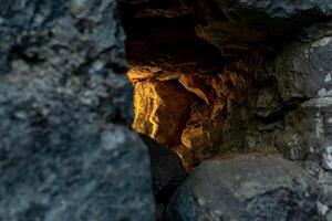 embrasure in the old fortress wall through which light breaks, close-up photo