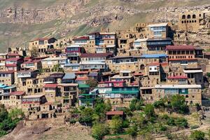 facades of houses located in tiers on a steep slope in the village of Chokh in Dagestan photo