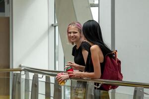 two teenage girls talking and laughing indoor photo