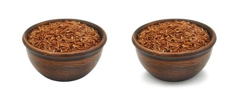 brown rice in clay bowl on white background, isolated and with shadow photo