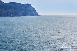 view of the winter sea with a high cliff photo