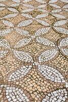 antique mosaic pavement with a pattern of tiles photo