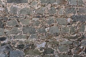 background, texture - ancient masonry at the wall of the castle photo