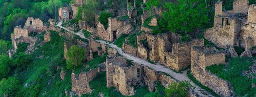 aerial view of the former street among the ruins in the abandoned mountain village of gamsutl in Dagestan photo