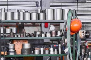 fragment of industrial interior with a storage of metal products and tools in the workshop photo