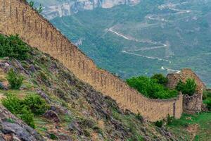 medieval fortress wall on a mountain slope, Gunib Shamil fortress in Dagestan photo