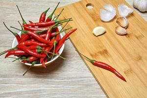 still life with pods of red hot pepper and cloves of garlic photo