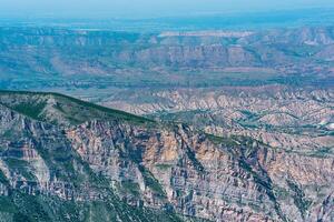 mountain landscape in the Caucasus with a view of the valley of the Sulak River and the towns below on the plain photo