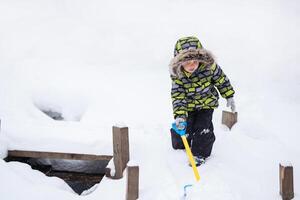 little child walking in winter snowy park photo