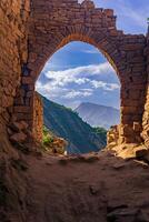 beautiful stone arch in the ruins of the abandoned ancient village of Gamsutl, Dagestan photo