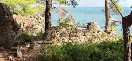 ruins of ancient buildings on the seashore on the site of the former harbor of Phaselis, Turkey photo