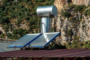 solar thermal water heating collector on the roof of the house photo