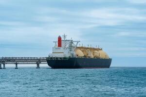 liquefied natural gas tanker vessel during loading at an LNG offshore terminal photo