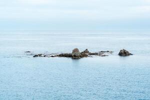 underwater rocks, reefs on a stone bank in the middle of the sea photo