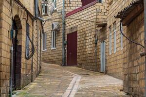 narrow street with old houses in the historical district of Derbent, Dagestan photo