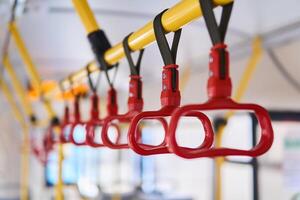 grab handles in the passenger compartment of the bus on a blurred background photo