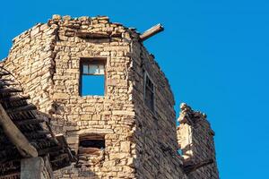 ruins of stone house against the sky in the ancient abandoned village of Gamsutl photo