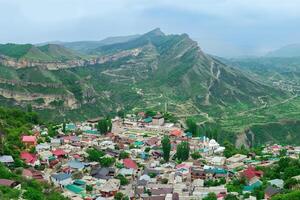 mountain town in a misty valley among impressive mountains, Gunib village in Dagestan photo