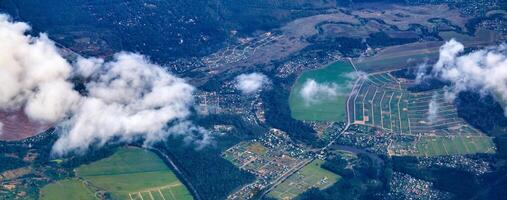 view from the plane to a densely populated region with villages and fields photo