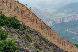 medieval fortress wall on a mountain slope, Gunib Shamil fortress in Dagestan photo