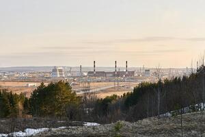 industrial landscape in early spring with a power station in the valley photo