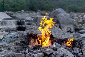 constantly burning fire at the place of a natural gas emission on Mount Chimaera Yanartas, Turkey photo