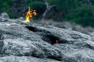constantly burning fires at the place of a natural gas emission on Mount Chimaera Yanartas, Turkey photo