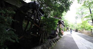 A historic wooden wheel on the water surface in Tokyo wide shot video