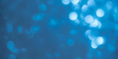 Sparkles defocus light. Glitter paper defocus as background. Blue. photo